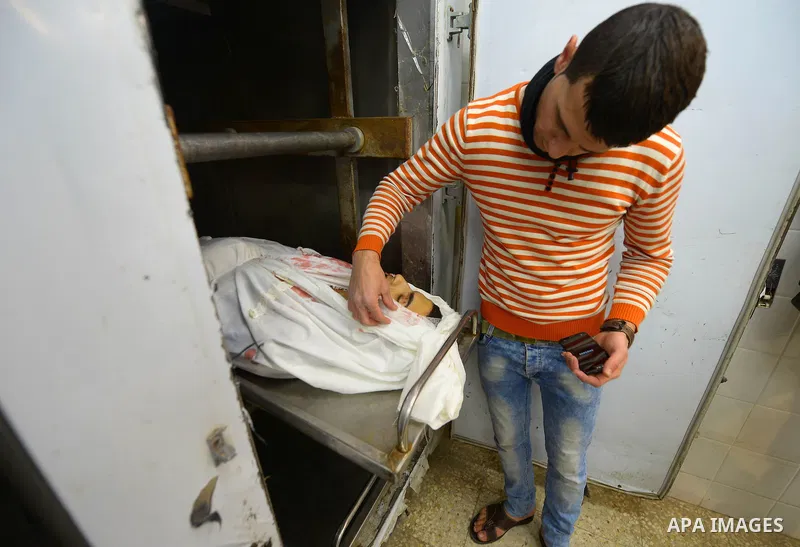 Relatives of Palestinian Mohammed Abu Zayed,who died after being shot in the neck by Israeli security forces at a protest, mourn over his body at a morgue in the central Gaza Strip January 15, 2016. A Palestinian was sho...