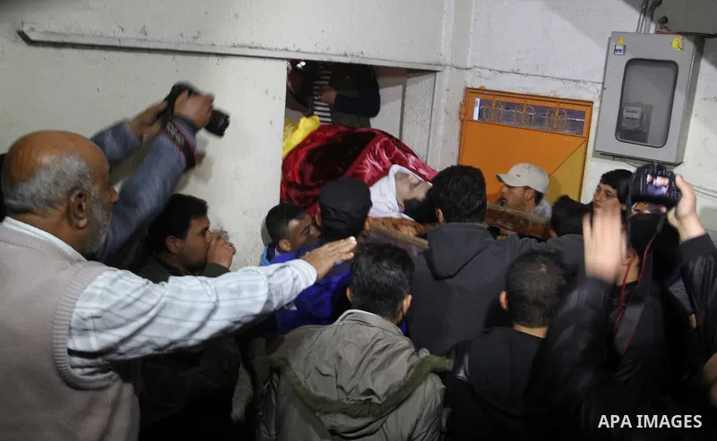 Palestinian carry the body of Mohammed Qita during his funeral, in Khan Yunis in the southern Gaza Strip on January 16, 2016. Two Palestinians were shot dead by Israeli forces during protests along the border with Gaza o...