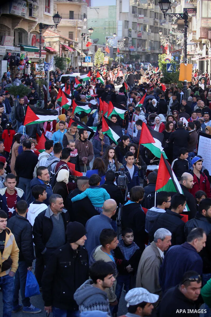 Palestinians from a human chain hold banners during a rally to show solidarity with the Palestine’s martyrs of the Intifada Jerusalem , in the West Bank city of Ramallah, on January 16, 2016. This has brought the number...