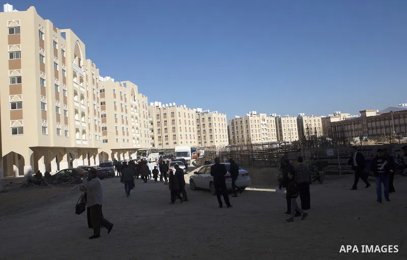Palestinians gather at the Qatari-funded Hamad City housing complex in Khan Younis, southern Gaza Strip, Saturday, Jan. 16, 2016. More than 1,000 Palestinian families have taken possession of new apartments in the first...