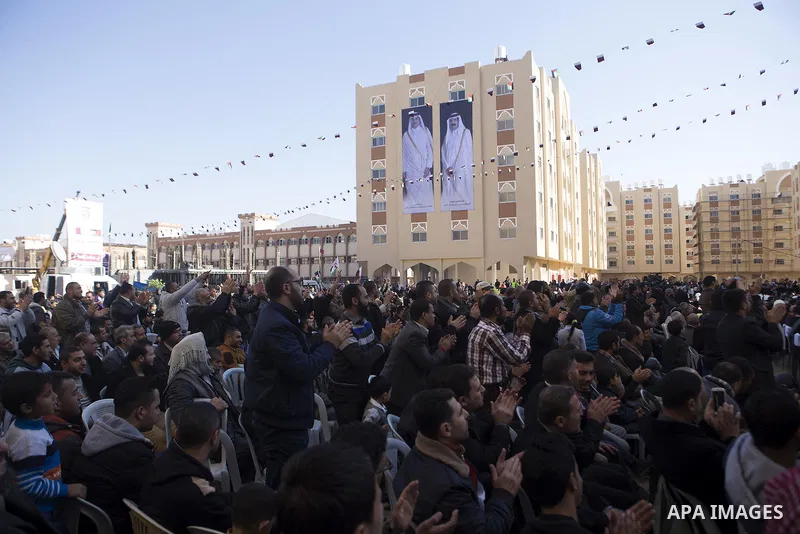 Palestinians gather at the Qatari-funded Hamad City housing complex in Khan Younis, southern Gaza Strip, Saturday, Jan. 16, 2016. More than 1,000 Palestinian families have taken possession of new apartments in the first...