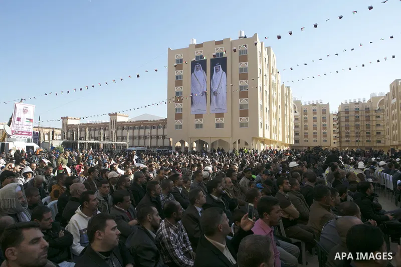 Palestinians gather at the Qatari-funded Hamad City housing complex in Khan Younis, southern Gaza Strip, Saturday, Jan. 16, 2016. More than 1,000 Palestinian families have taken possession of new apartments in the first...