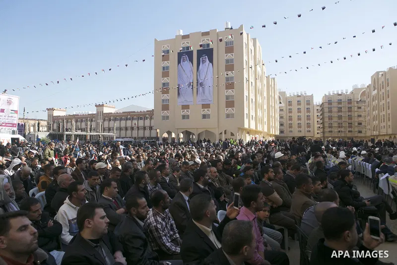 Palestinians gather at the Qatari-funded Hamad City housing complex in Khan Younis, southern Gaza Strip, Saturday, Jan. 16, 2016. More than 1,000 Palestinian families have taken possession of new apartments in the first...