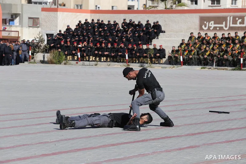 Palestinian members of officers display their skills during a graduation ceremony, in Gaza city on January 17, 2016. Photo by Mohammed Asad