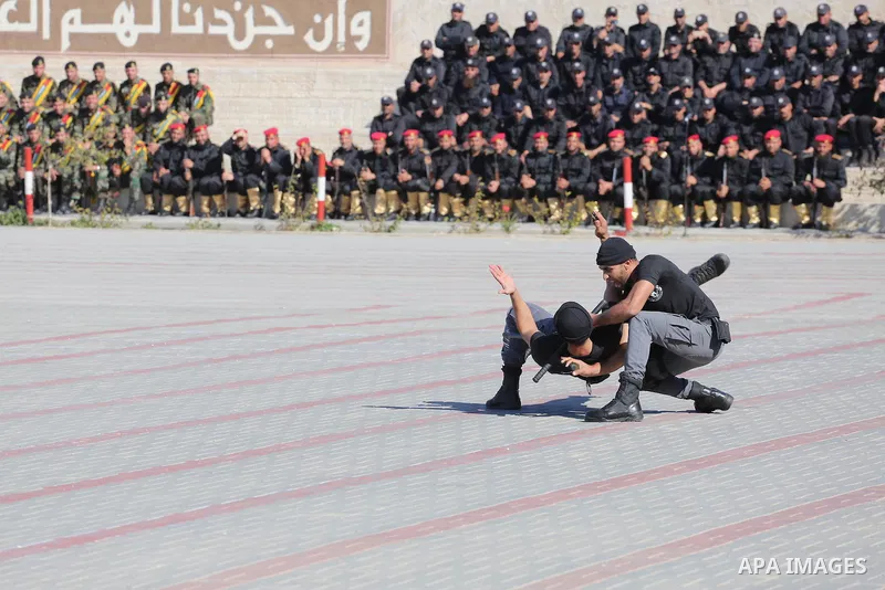 Palestinian members of officers display their skills during a graduation ceremony, in Gaza city on January 17, 2016. Photo by Mohammed Asad