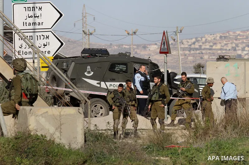 Israeli security forces gather near the scene where a Palestinian man was shot dead following a reported stabbing attack at the Hawara checkpoint, south of the West Bank city of Nablus, on Jan. 17, 2016. Israeli army Sun...