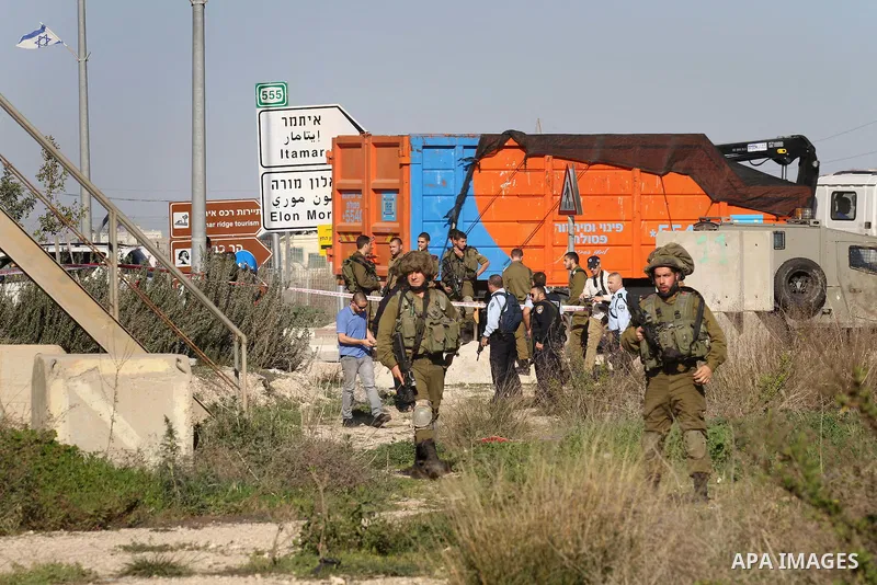 Israeli security forces gather near the scene where a Palestinian man was shot dead following a reported stabbing attack at the Hawara checkpoint, south of the West Bank city of Nablus, on Jan. 17, 2016. Israeli army Sun...