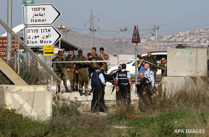 Israeli security forces gather near the scene where a Palestinian man was shot dead following a reported stabbing attack at the Hawara checkpoint, south of the West Bank city of Nablus, on Jan. 17, 2016. Israeli army Sun...