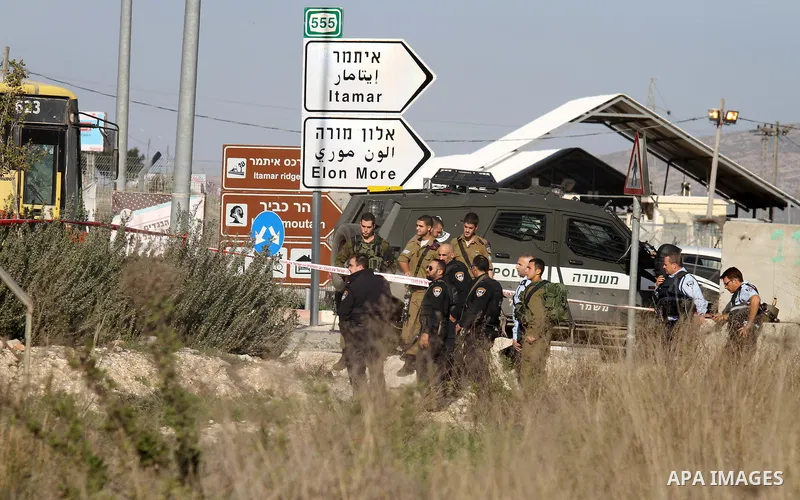 Israeli security forces gather near the scene where a Palestinian man was shot dead following a reported stabbing attack at the Hawara checkpoint, south of the West Bank city of Nablus, on Jan. 17, 2016. Israeli army Sun...