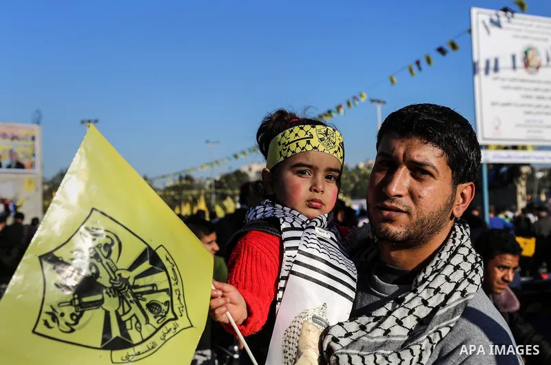 Palestinian Fatah supporters celebrate during a rally as they mark the 51st anniversary of the founding of the Fatah movement, in Beit Lahia in the northern Gaza Strip, on Jan. 17, 2016. Photo by Nidal Alwaheidi