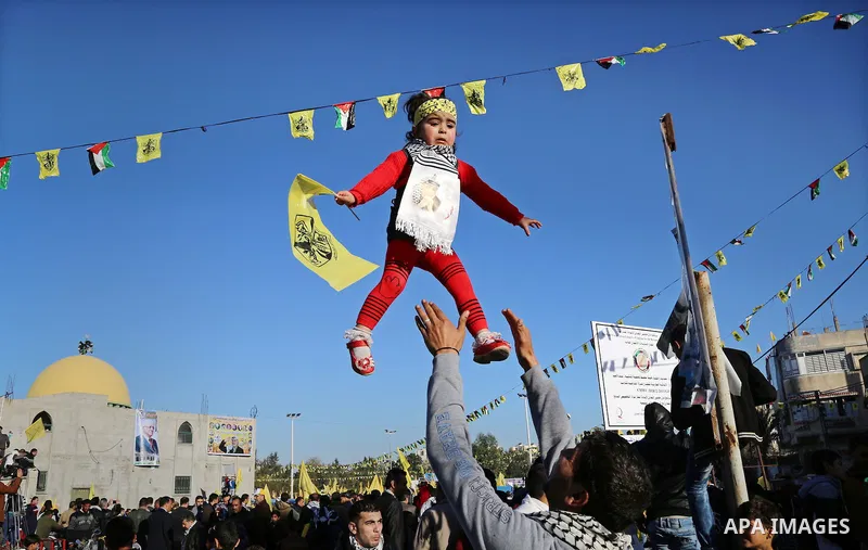 Palestinian Fatah supporters celebrate during a rally as they mark the 51st anniversary of the founding of the Fatah movement, in Beit Lahia in the northern Gaza Strip, on Jan. 17, 2016. Photo by Nidal Alwaheidi
