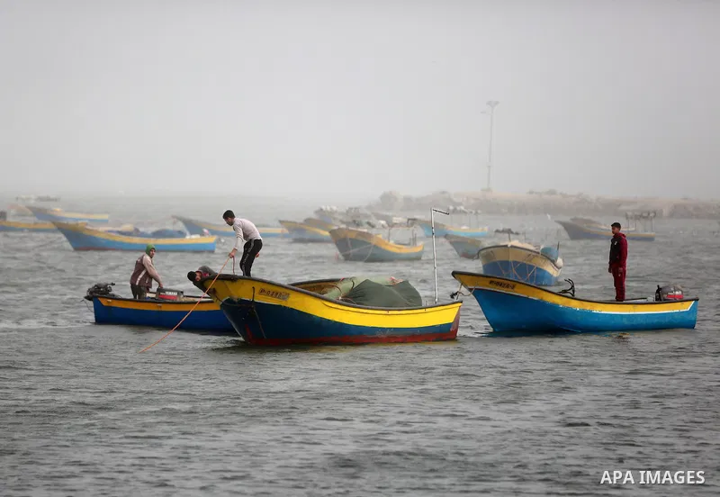 Fishing boats are seen at the Gaza port during a heavy storm on January 18, 2016. Photo by Yasser Qudih