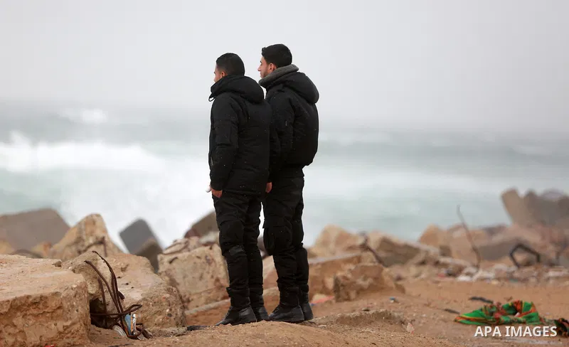 Palestinian policemen stand off the coast of Gaza city during a heavy storm on January 18, 2016. Photo by Yasser Qudih