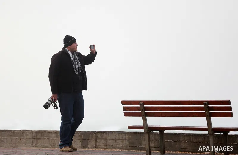 A Palestinian man takes a selfie as he stands off the coast of Gaza city during a heavy storm on January 18, 2016. Photo by Yasser Qudih