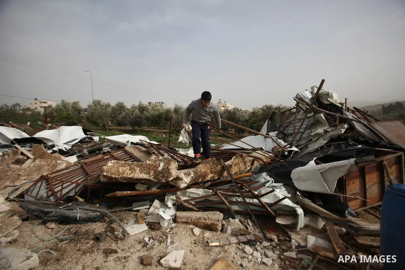 Palestinians inspect the rubble of a farm that was demolished after Israeli authorities said it was built without a permit on January 18, 2016 in the West Bank village al-Fundoq east of the village of Qalqiliya. Photo by...