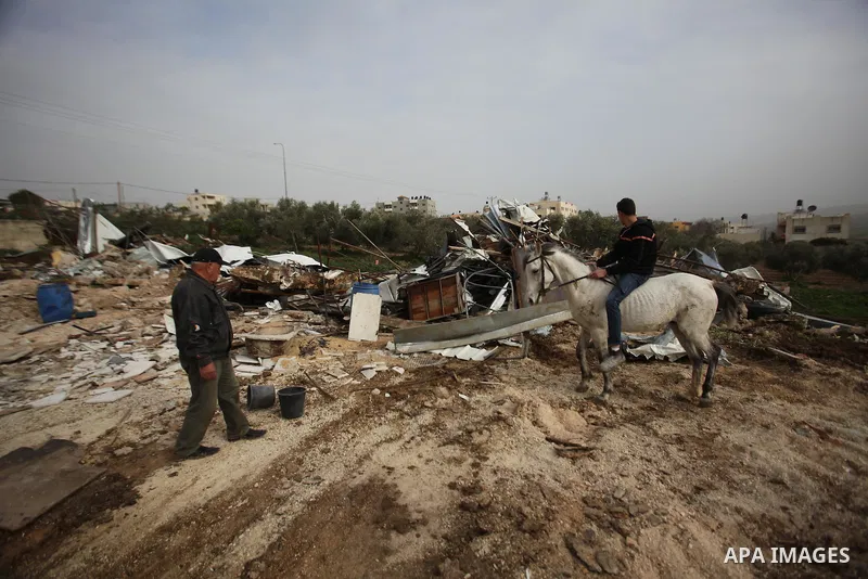 Palestinians inspect the rubble of a farm that was demolished after Israeli authorities said it was built without a permit on January 18, 2016 in the West Bank village al-Fundoq east of the village of Qalqiliya. Photo by...