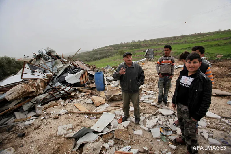 Palestinians inspect the rubble of a farm that was demolished after Israeli authorities said it was built without a permit on January 18, 2016 in the West Bank village al-Fundoq east of the village of Qalqiliya. Photo by...