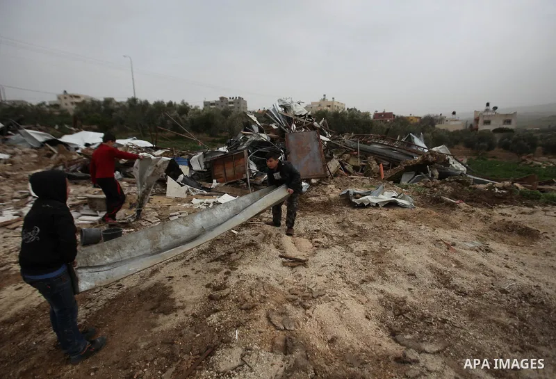 Palestinians inspect the rubble of a farm that was demolished after Israeli authorities said it was built without a permit on January 18, 2016 in the West Bank village al-Fundoq east of the village of Qalqiliya. Photo by...