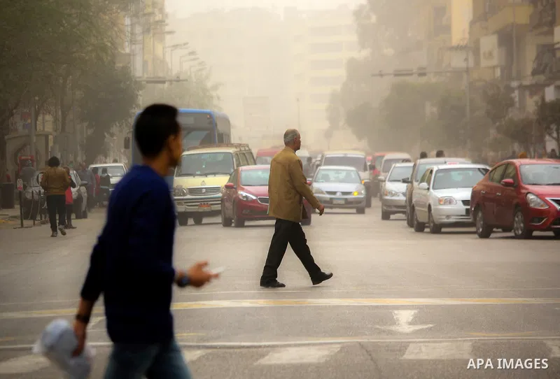 Egyptians walk at a street during sandstorm in Cairo, Egypt, on Jan. 18, 2016. Photo by Amr Sayed
