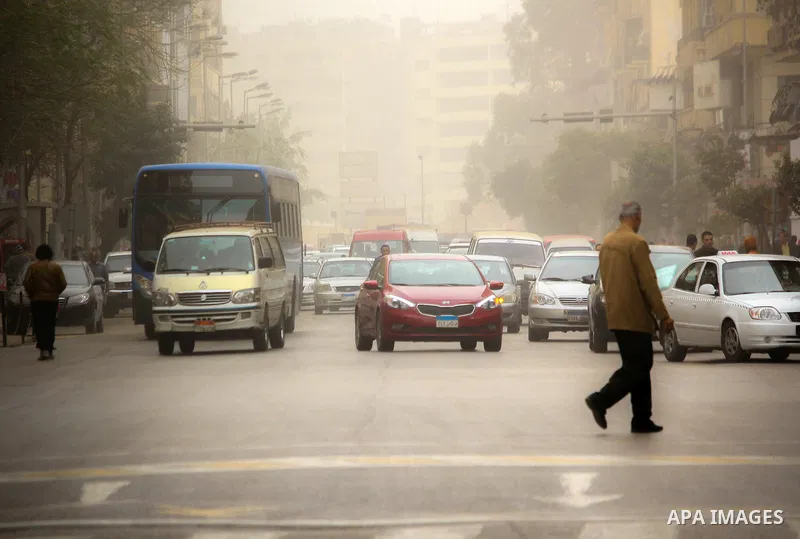 Egyptians walk at a street during sandstorm in Cairo, Egypt, on Jan. 18, 2016. Photo by Amr Sayed