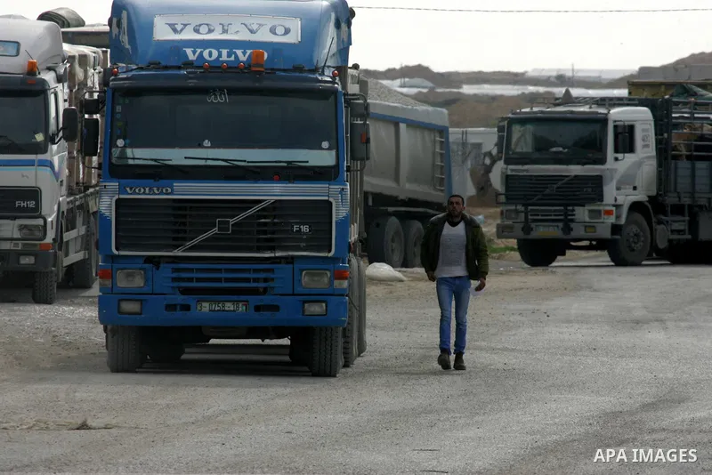 Trucks loaded with goods enter the Gaza Strip from Israel through the Kerem Shalom crossing in Rafah in the southern Gaza Strip on Jan. 18, 2016. Photo by Abed Rahim Khatib