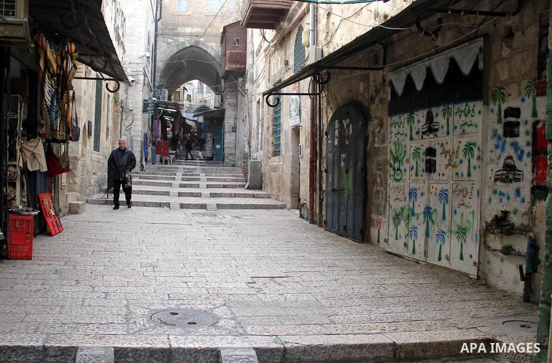 Palestinians walk at market in Jerusalem's old city on Jan. 18, 2016. Photo by Mahfouz Abu Turk