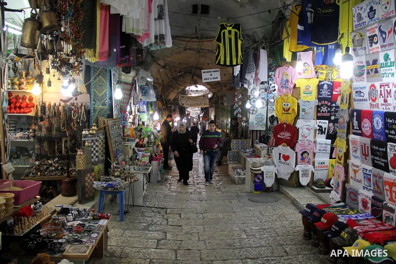 Palestinians walk at market in Jerusalem's old city on Jan. 18, 2016. Photo by Mahfouz Abu Turk