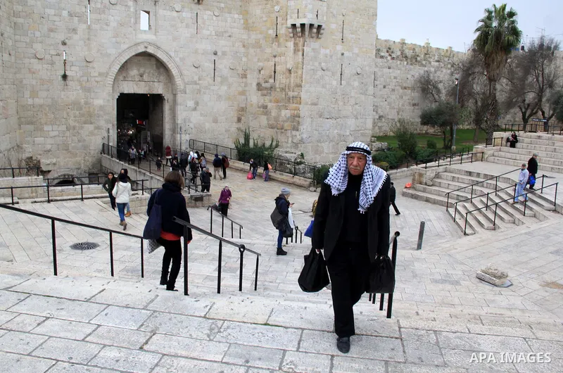 Palestinians walk in front of Damascus gate, in Jerusalem's old city on Jan. 19, 2016. Photo by Mahfouz Abu Turk