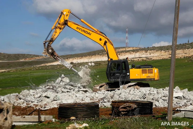 An Israeli bulldozer demolishes a Palestinian house under the order of the Israeli army, in the West Bank town of Dura, south of Hebron January 20, 2016. The owners of the house said they were informed by the Israeli arm...