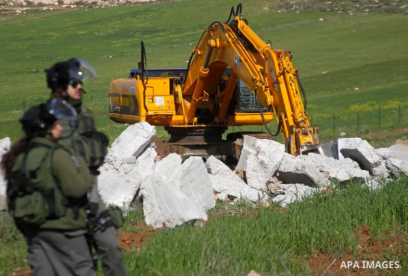 Israeli border policemen stand guard during the demolition of a Palestinian house under the order of the Israeli army, in the West Bank town of Dura, south of Hebron January 20, 2016. The owners of the house said they we...