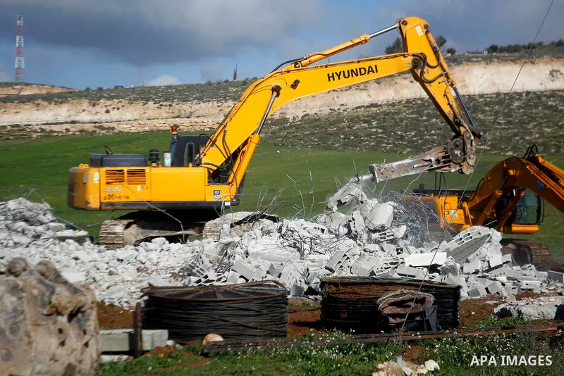 An Israeli bulldozer demolishes a Palestinian house under the order of the Israeli army, in the West Bank town of Dura, south of Hebron January 20, 2016. The owners of the house said they were informed by the Israeli arm...
