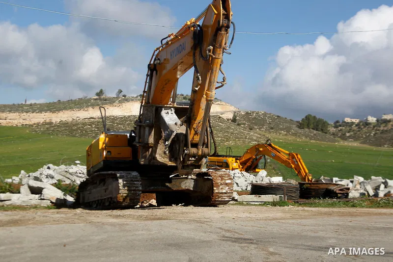 An Israeli bulldozer demolishes a Palestinian house under the order of the Israeli army, in the West Bank town of Dura, south of Hebron January 20, 2016. The owners of the house said they were informed by the Israeli arm...