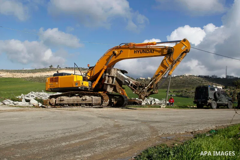 An Israeli bulldozer demolishes a Palestinian house under the order of the Israeli army, in the West Bank town of Dura, south of Hebron January 20, 2016. The owners of the house said they were informed by the Israeli arm...