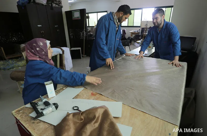 Palestinians disabled work on wood to make furniture during participate in a project titled "Erada" funded by the Turkish President Ragab Ardogan at the Islamic university, in Gaza City, on January 20, 2016. Photo by Moh...