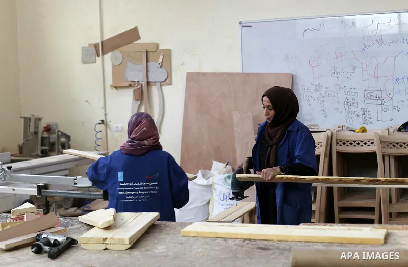 Palestinians disabled work on wood to make furniture during participate in a project titled "Erada" funded by the Turkish President Ragab Ardogan at the Islamic university, in Gaza City, on January 20, 2016. Photo by Moh...