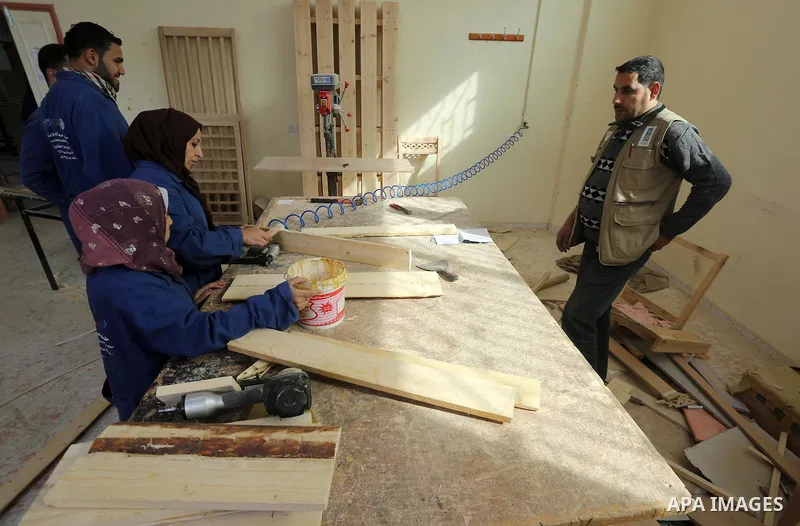 Palestinians disabled work on wood to make furniture during participate in a project titled "Erada" funded by the Turkish President Ragab Ardogan at the Islamic university, in Gaza City, on January 20, 2016. Photo by Moh...