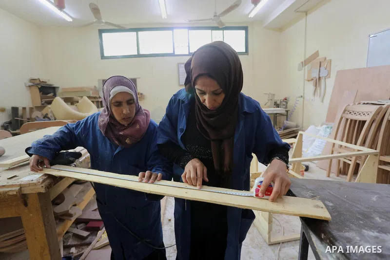 Palestinians disabled work on wood to make furniture during participate in a project titled "Erada" funded by the Turkish President Ragab Ardogan at the Islamic university, in Gaza City, on January 20, 2016. Photo by Moh...