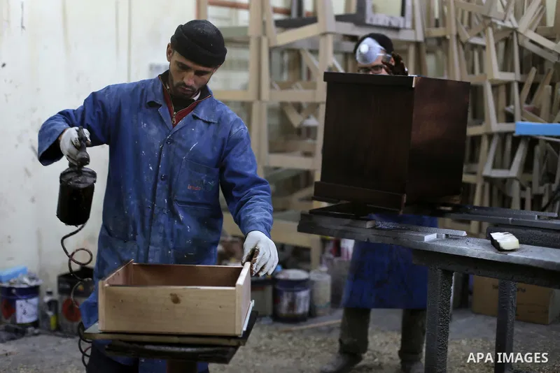 A Palestinian disabled works on wood to makes furniture during participate in a project titled "Erada" funded by the Turkish President Ragab Ardogan at the Islamic university, in Gaza City, on January 20, 2016. Photo by...
