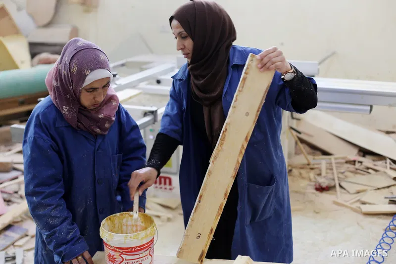 Palestinians disabled work on wood to make furniture during participate in a project titled "Erada" funded by the Turkish President Ragab Ardogan at the Islamic university, in Gaza City, on January 20, 2016. Photo by Moh...
