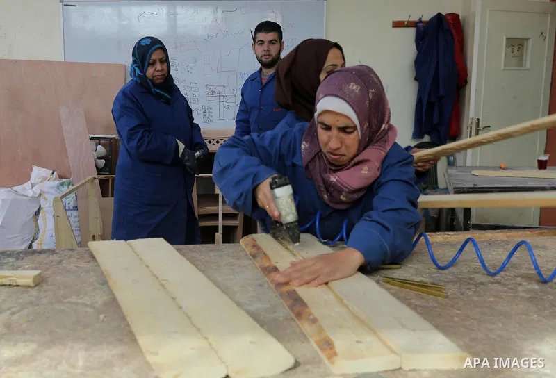 Palestinians disabled work on wood to make furniture during participate in a project titled "Erada" funded by the Turkish President Ragab Ardogan at the Islamic university, in Gaza City, on January 20, 2016. Photo by Moh...