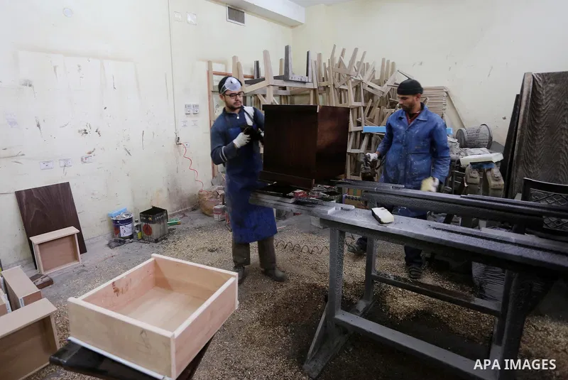 Palestinians disabled work on wood to make furniture during participate in a project titled "Erada" funded by the Turkish President Ragab Ardogan at the Islamic university, in Gaza City, on January 20, 2016. Photo by Moh...