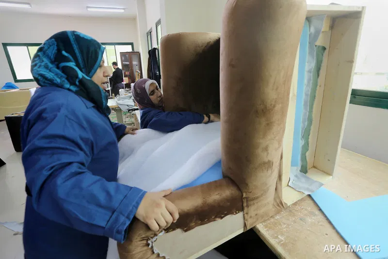 A Palestinian disabled works on wood to makes furniture during participate in a project titled "Erada" funded by the Turkish President Ragab Ardogan at the Islamic university, in Gaza City, on January 20, 2016. Photo by...