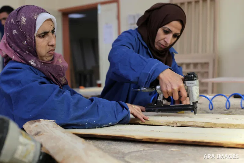 Palestinians disabled work on wood to make furniture during participate in a project titled "Erada" funded by the Turkish President Ragab Ardogan at the Islamic university, in Gaza City, on January 20, 2016. Photo by Moh...