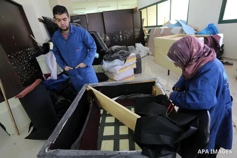 Palestinians disabled work on wood to make furniture during participate in a project titled "Erada" funded by the Turkish President Ragab Ardogan at the Islamic university, in Gaza City, on January 20, 2016. Photo by Moh...