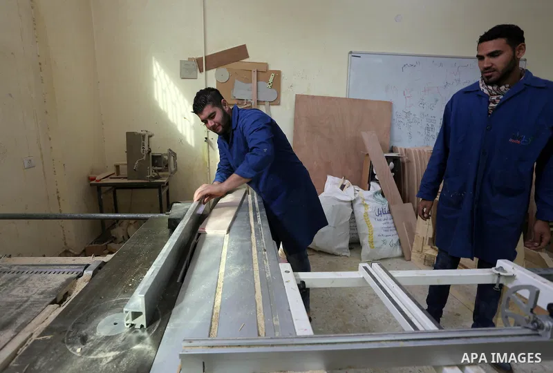 Palestinians disabled work on wood to make furniture during participate in a project titled "Erada" funded by the Turkish President Ragab Ardogan at the Islamic university, in Gaza City, on January 20, 2016. Photo by Moh...
