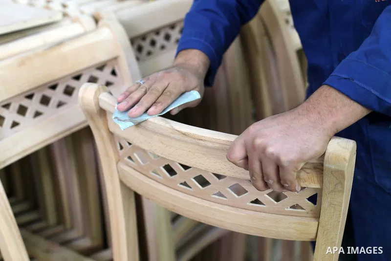 A Palestinian disabled works on wood to makes furniture during participate in a project titled "Erada" funded by the Turkish President Ragab Ardogan at the Islamic university, in Gaza City, on January 20, 2016. Photo by...