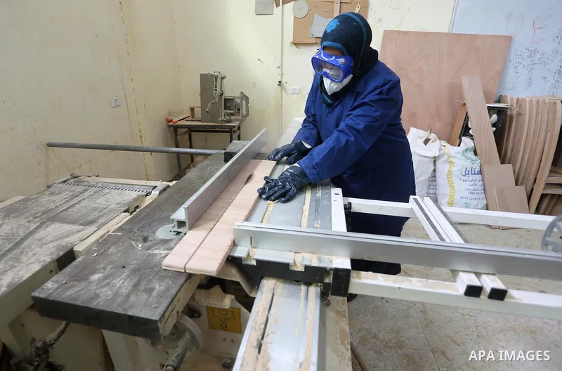 A Palestinian disabled works on wood to makes furniture during participate in a project titled "Erada" funded by the Turkish President Ragab Ardogan at the Islamic university, in Gaza City, on January 20, 2016. Photo by...
