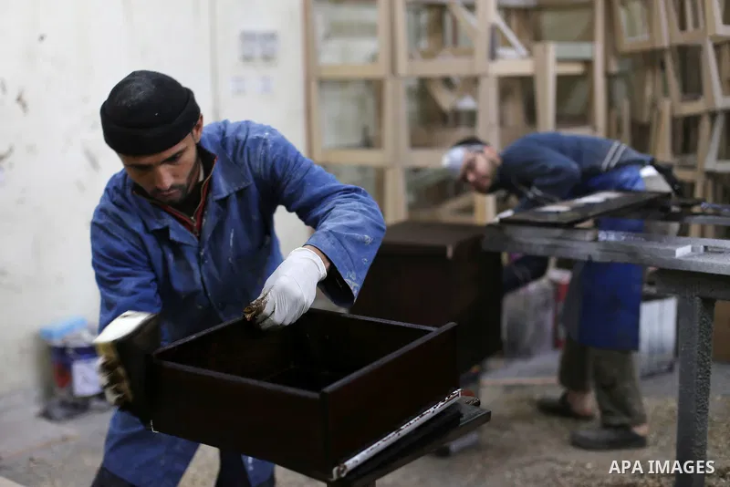 Palestinians disabled work on wood to make furniture during participate in a project titled "Erada" funded by the Turkish President Ragab Ardogan at the Islamic university, in Gaza City, on January 20, 2016. Photo by Moh...