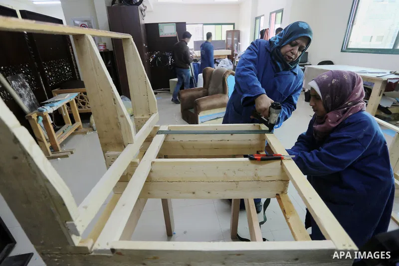 Palestinians disabled work on wood to make furniture during participate in a project titled "Erada" funded by the Turkish President Ragab Ardogan at the Islamic university, in Gaza City, on January 20, 2016. Photo by Moh...