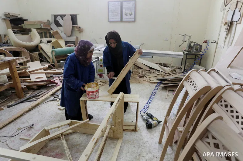 Palestinians disabled work on wood to make furniture during participate in a project titled "Erada" funded by the Turkish President Ragab Ardogan at the Islamic university, in Gaza City, on January 20, 2016. Photo by Moh...